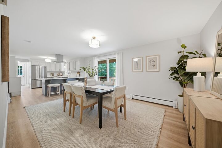 Dining area beside the kitchen and a sliding door to the deck at 7 Twin Street, Windham, NH