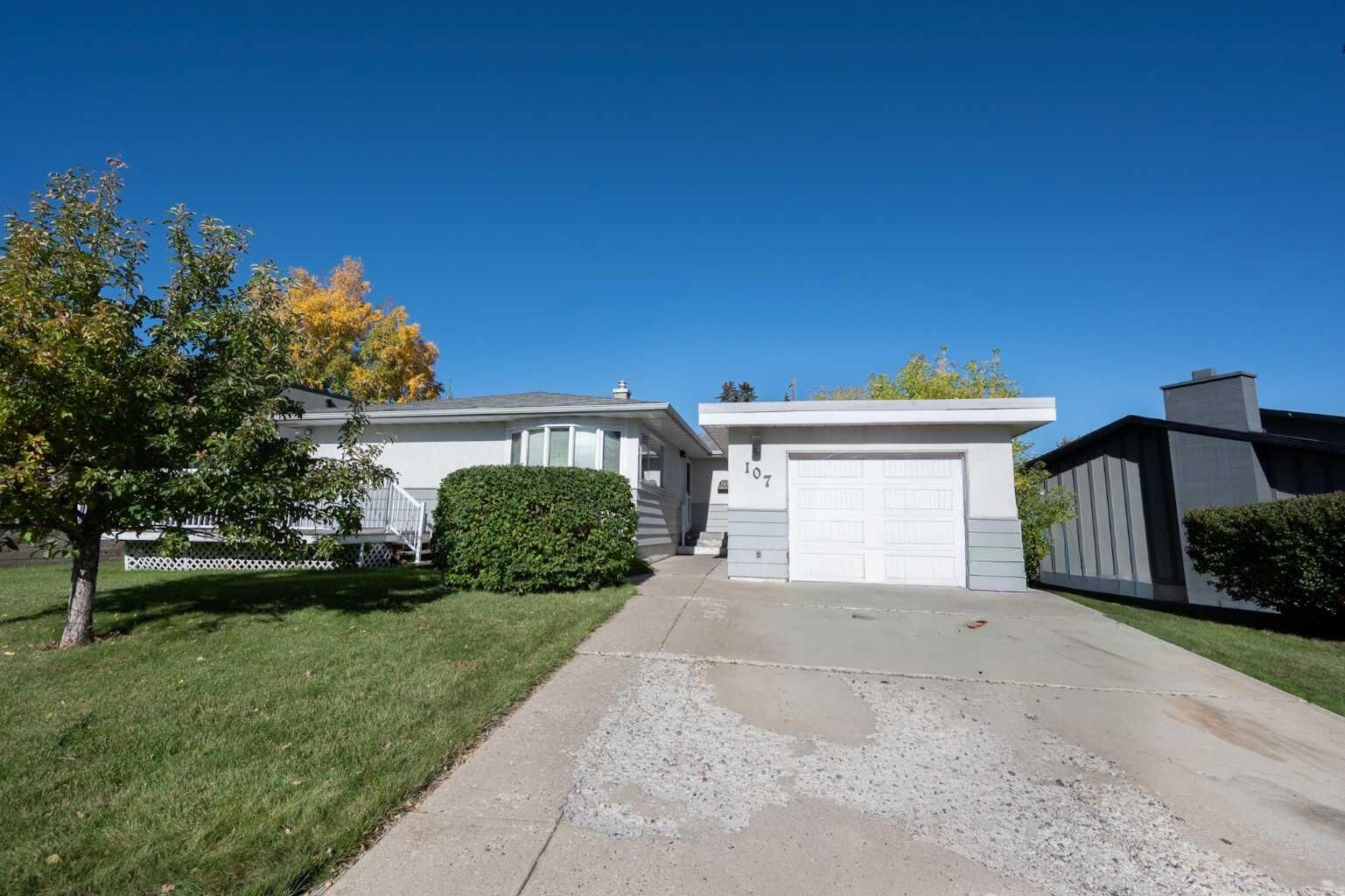 Property Photo: 107 Hallbrook Drive SW AB T2V 3H8