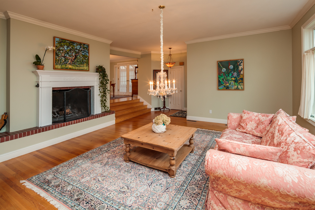 Property Photo: Looking across the living room toward the entry (on the other side of the wall to the right), and the dining area and sun room beyond. oak flooring and tall ceilings with crown molding throughout most of the living space. this home is ideal for entertaini 819 14th St  WA 98225 